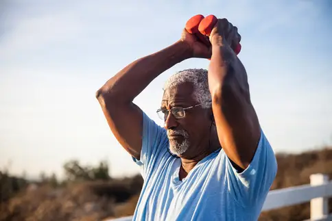 photo of man lifting weights