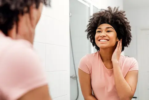 photo of girl looking in mirror