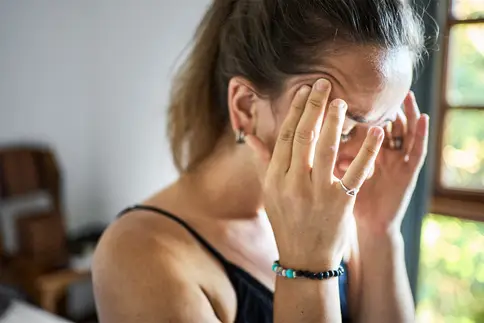 photo of woman touching her temples while suffering from headache