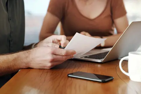 photo of couple using a laptop