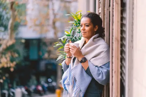 photo of woman drinking coffee outside