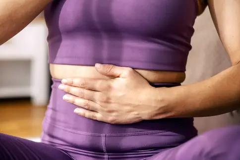 photo of hand on stomach during breathing exercise