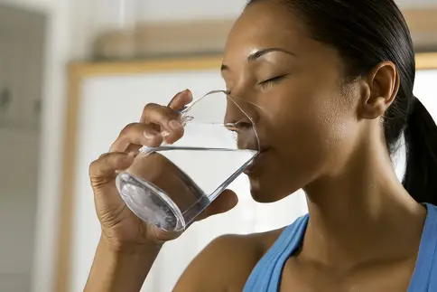 photo of woman drinking water