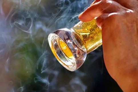 hand holding beer and cigarette