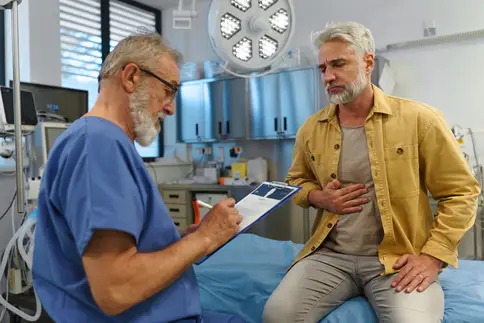 photo of doctor talking with patient about his symptoms