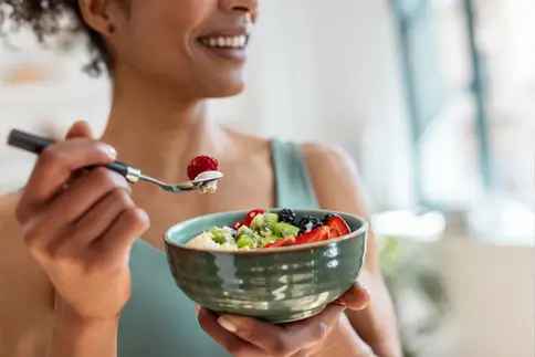photo of woman eating healthy salad