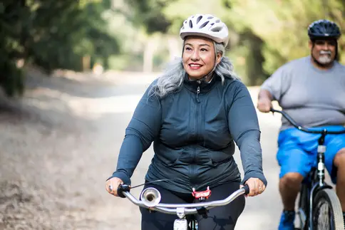photo of older couple biking outside