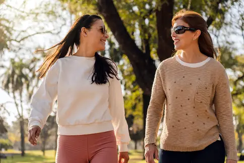 photo of young 20s friends walking for exercise in park