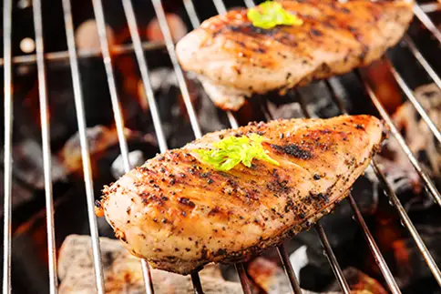 photo of Seasoned chicken breasts on grill