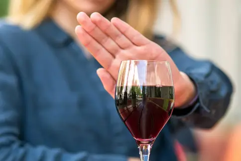 photo of woman saying no to red wine
