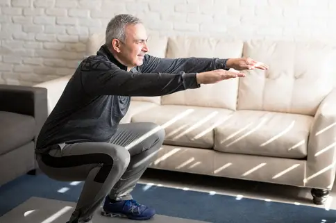 photo of man doing squats
