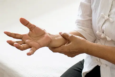 photo of woman holding arm