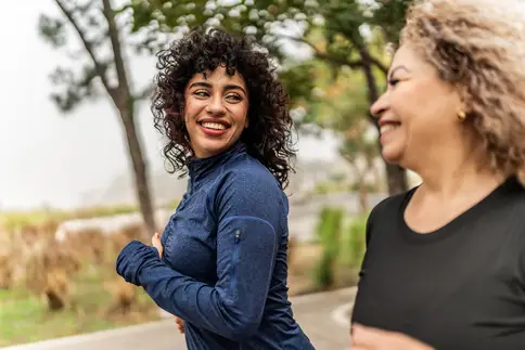 photo of mother and adult daughter jogging in park