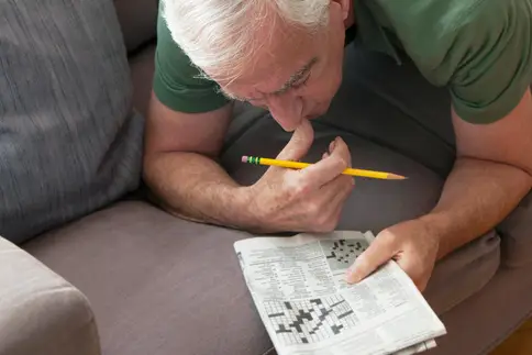 man working crossword
