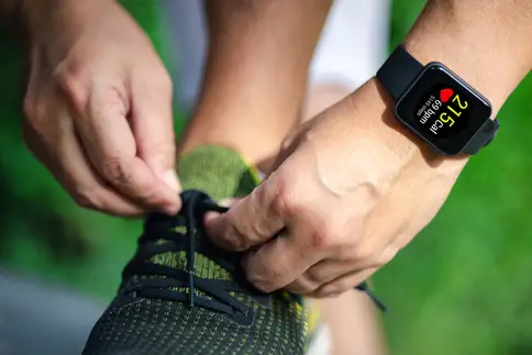photo of mature man taking notes by window at home