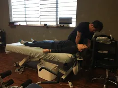 Dr. Kim helping patient