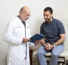 Dr. Adrouny with his patient during consultation.