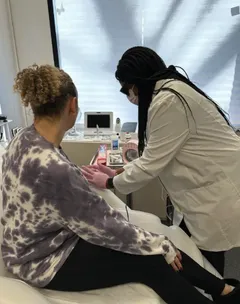 Regina providing care for a patient in the clinic.