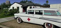 The iconic 1957 Chevy, Natural Medicine & Detox ambulance, parked outside their clinic