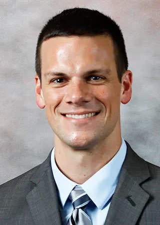 Travis J Dams
