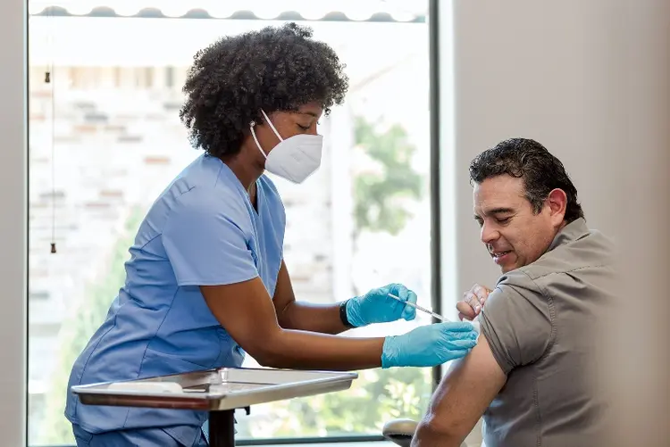 photo of mature man receiving vaccination