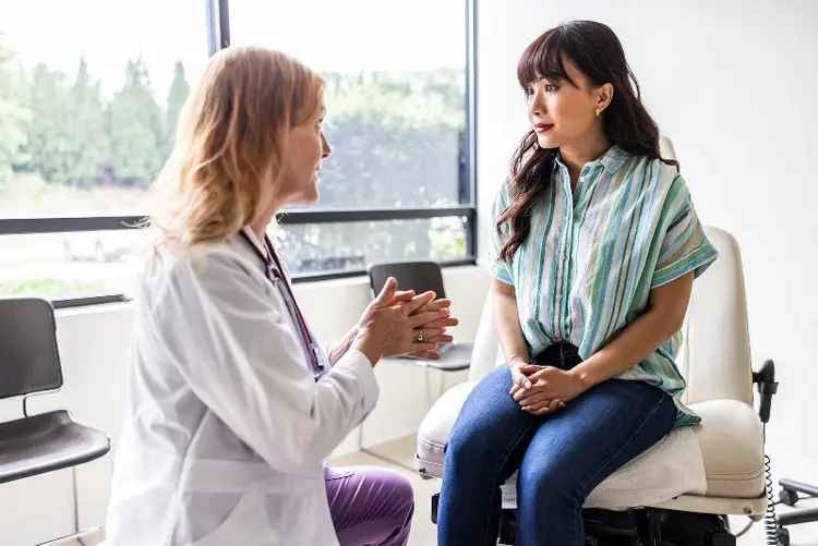 photo of doctor talking with mature female patient