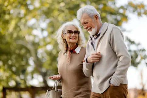 Senior couple walking in park