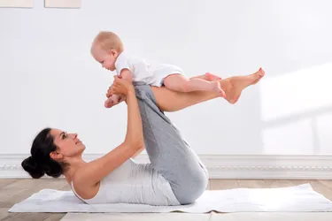 You can do some workouts with your baby. You may want to practice first with a doll or a rolled-up towel to make sure you can do the moves safely. (Photo credit: Iurii Sokolov/Dreamstime)