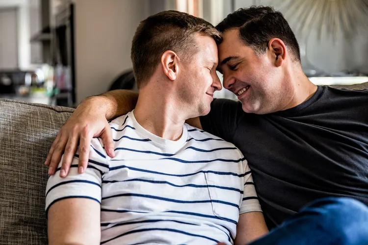 photo of Gay couple embracing on couch