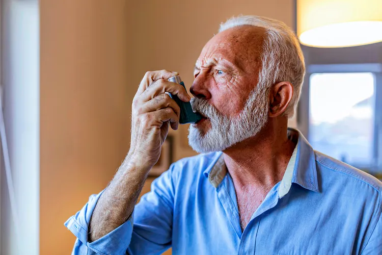 photo of man using medical inhaler