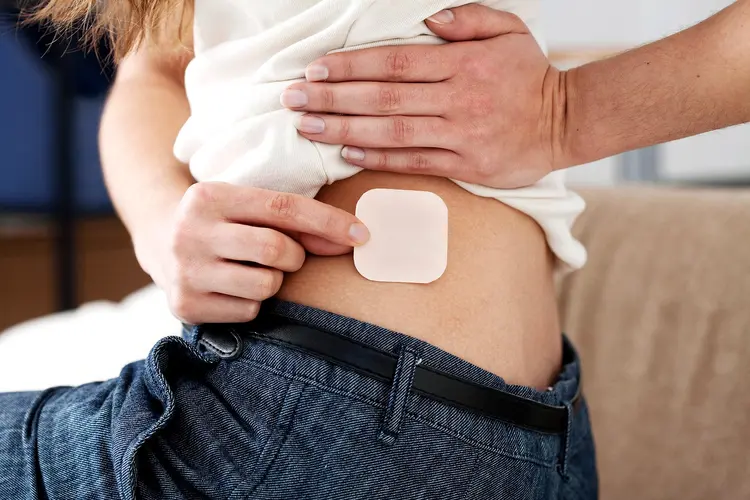 photo of woman applying birth control patch