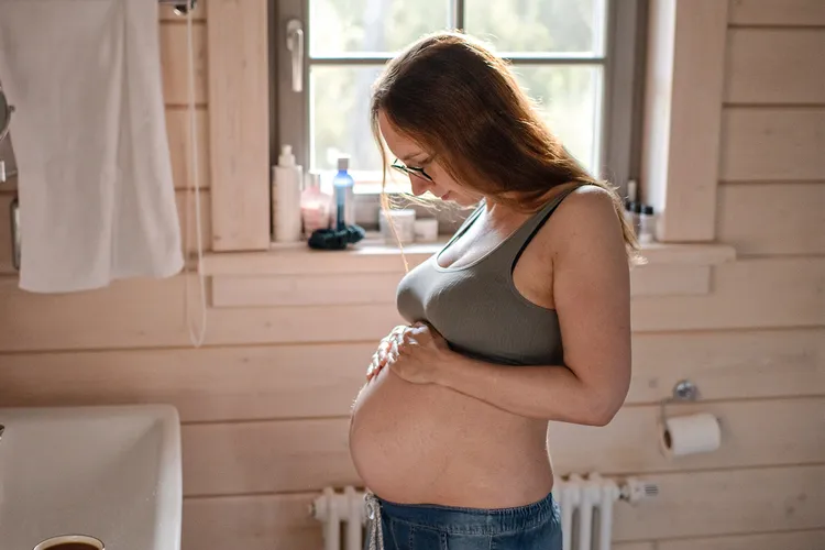 photo of  Pregnant woman looking at her belly