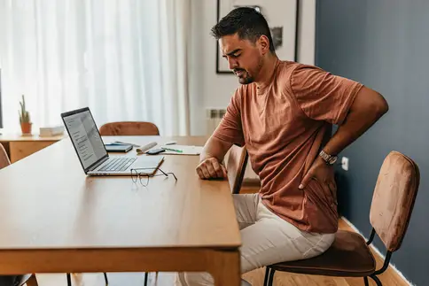 photo of  man experiencing sharp back pain