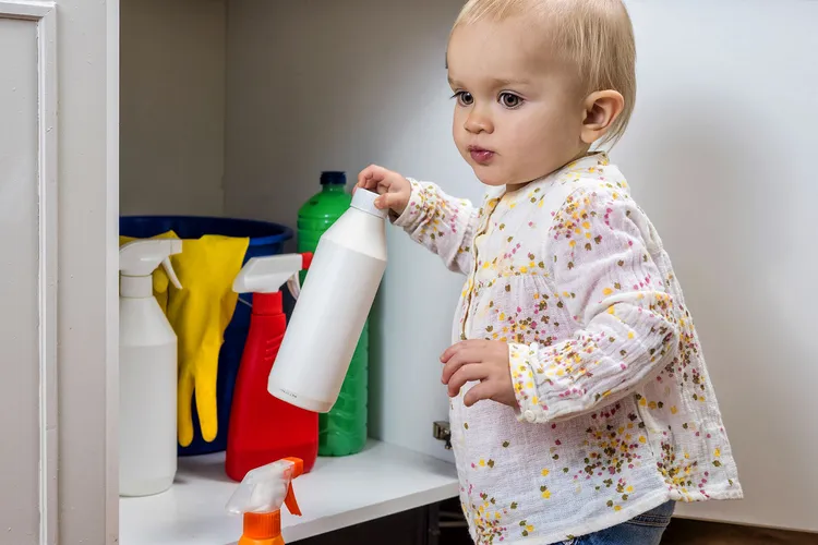 photo of girl playing with household cleaners