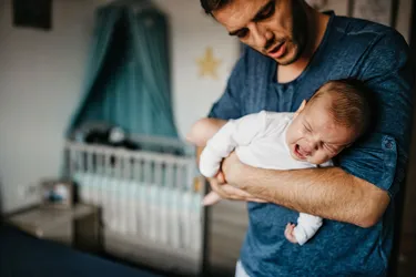 Some people find it helps to hold a crying baby with colic across your forearm with pressure on their tummy. Other ways to soothe them include massage, rocking, a warm bath, or car ride. (Photo Credit: Credit: E+/Getty Images)