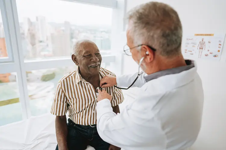 photo of doctor listening to heart beat