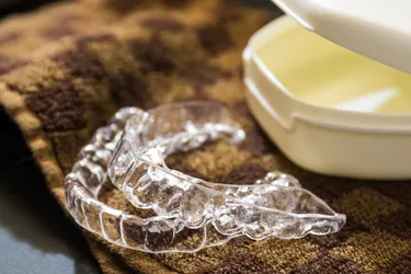 If you grind your teeth at night, a mouth guard can help protect them from damage. (Photo Credit: iStock/Getty Images)