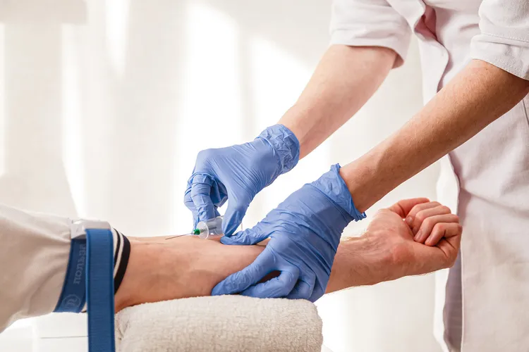 photo of  nurse draws blood from a vein