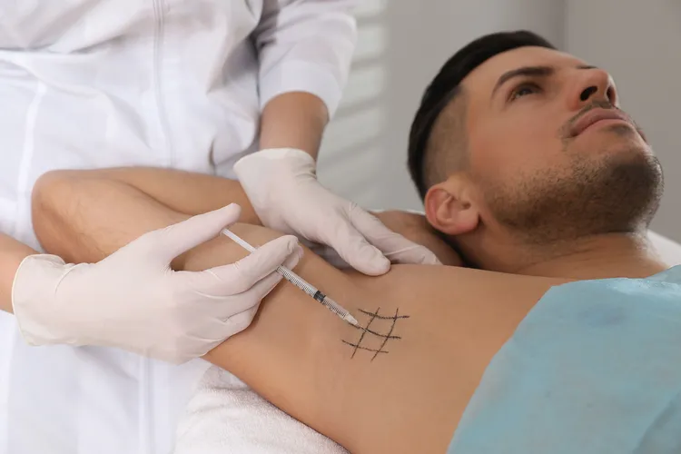 photo of man getting botox injection in armpit