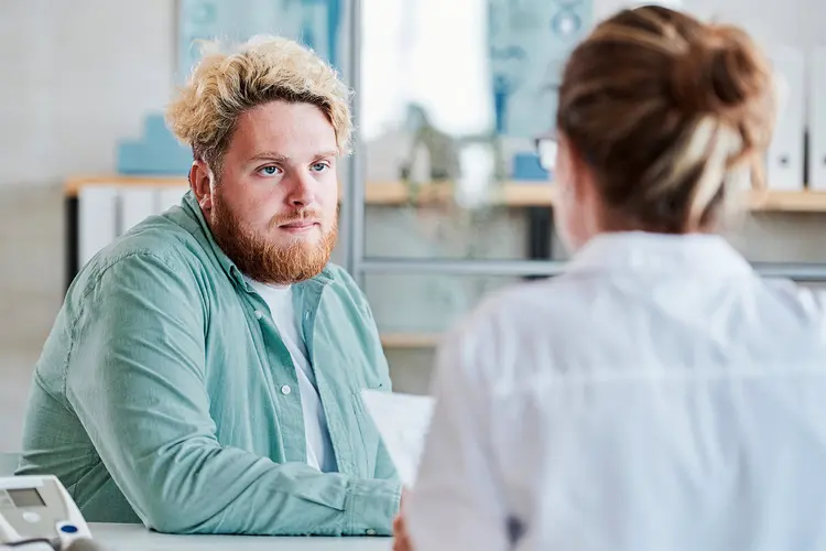 photo of White man talking to patient
