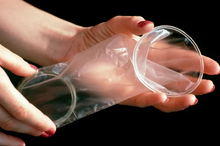 photo of hands holding female condom