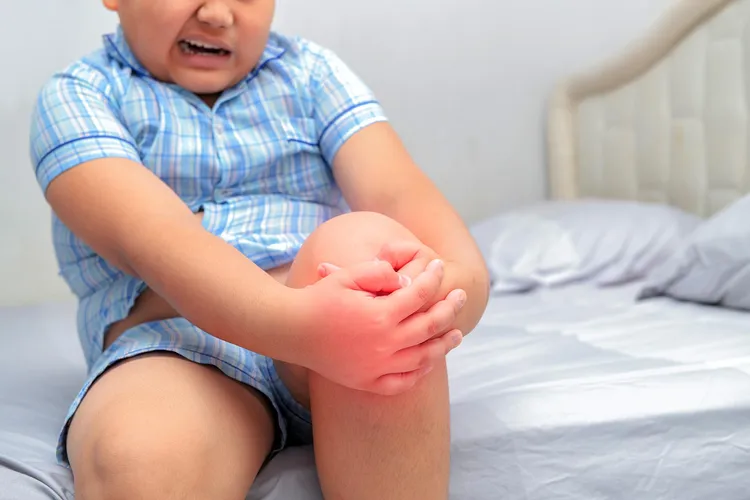 photo of Boy suffering from knee pain