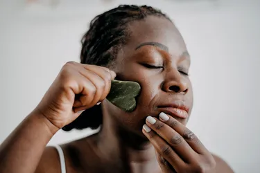 Gua sha shouldn't hurt. On your face, use gentle pressure and smooth strokes to get the benefits. (Photo Credit: iStock/Getty Images)
