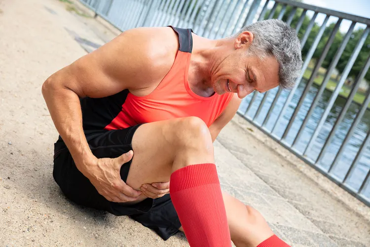 photo of mature man with strained hamstring muscle