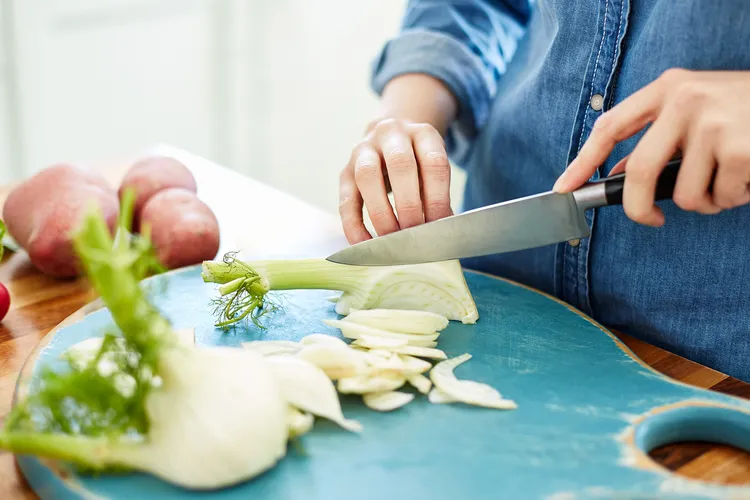 photo of woman cutting fennel 