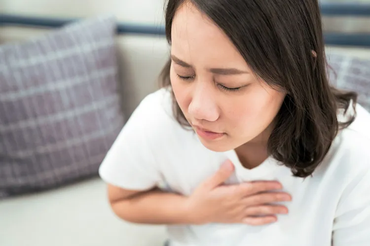 photo of young woman experiencing heartburn