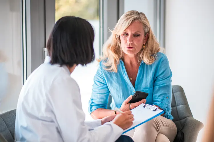 photo of woman talking to doctor
