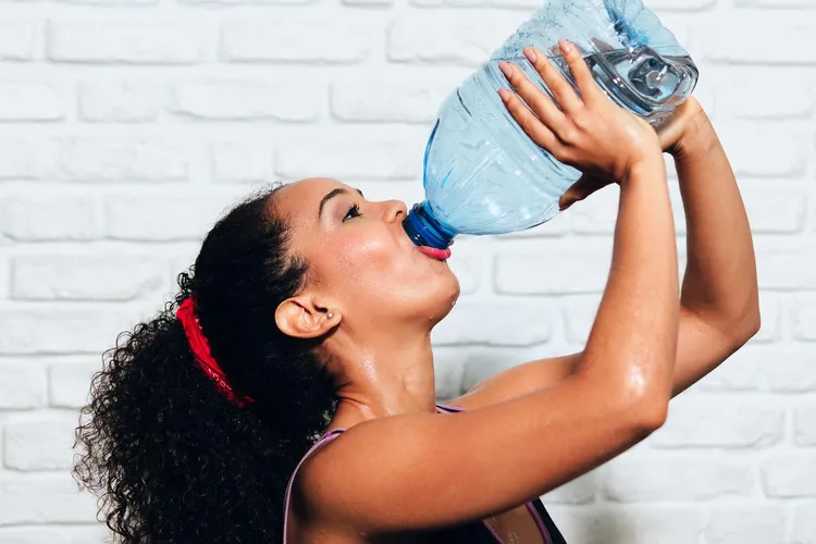 photo of woman drinking gallon of water