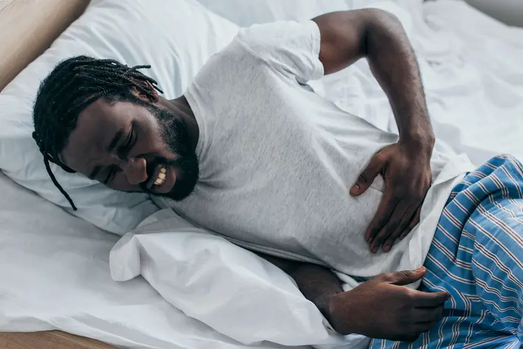 photo of man suffering from abdominal pain