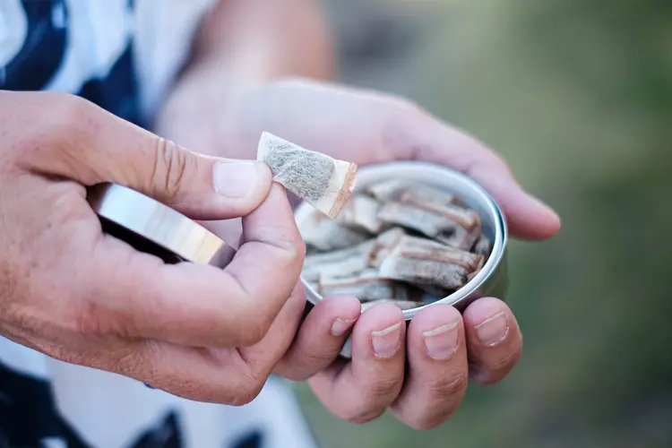 photo of holding a box of snus, snuff
